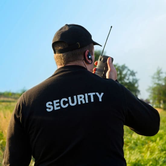 A man in black shirt holding a radio.